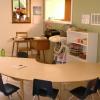 You can see the shelf with Puzzles and Games. The Table is used for meal times and preschool activities.  You can see my desk in the back as well.